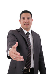 Image showing A business man with an open hand ready to seal a deal. Focus in 