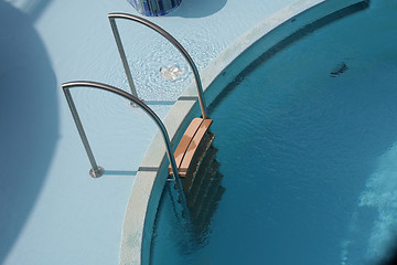 Image showing Pool ladder and swimming pool 