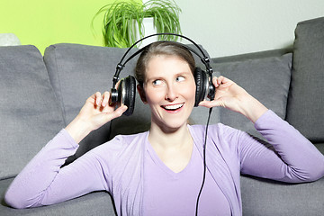 Image showing Laughing mature woman listening to music