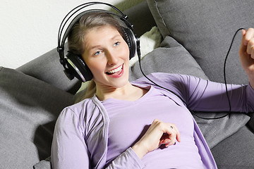 Image showing Middle-aged woman enjoying music