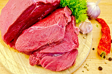 Image showing Meat beef on a wooden board with vegetables
