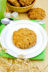 Image showing Biscuits with stalks of oats on a wooden board