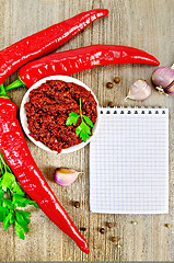 Image showing Adjika with fresh chili peppers and a notepad