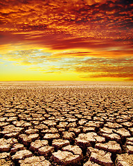 Image showing drought land under red clouds