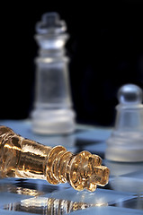 Image showing Chess king lays on a chessboard. A victory and defeat. 