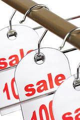 Image showing Sale. A hanger with labels on a white background.