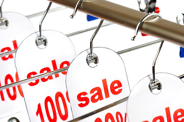 Image showing Sale. A hanger with labels on a white background.