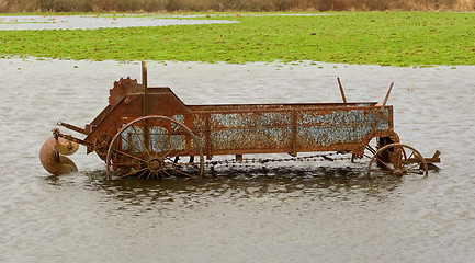 Image showing Flooded Antique Farming Equipment