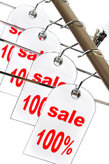 Image showing Sale. A hanger with labels on a white background.