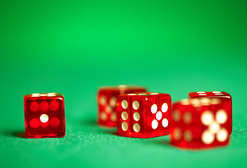 Image showing red dices on green cloth