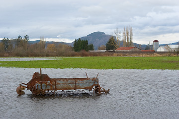 Image showing Flooded Antique Farming Equipment 2