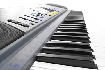 Image showing Keys of a synthesizer in white bright light.