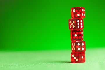 Image showing red dices on green cloth