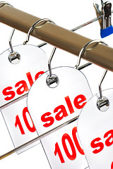 Image showing Sale. A hanger with labels on a white background.