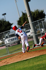 Image showing Little league pitcher throwing to first