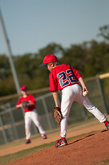 Image showing Little league baseball pitcher looking at batter.