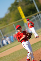 Image showing Little league pitcher looking at third