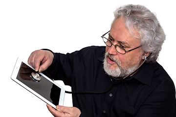 Image showing Senior is doing tablet pc diagnosis