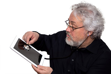 Image showing Senior is doing tablet pc diagnosis