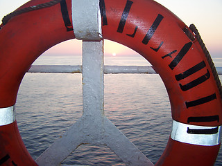 Image showing Peace life buoy at susnset over the sea