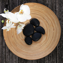 Image showing Massage stones in a pottery bowl