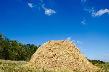 Image showing stack of straw under deep blue sky
