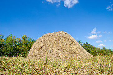 Image showing stack of straw under deep blue sky