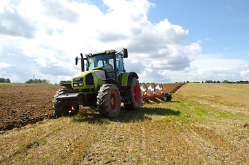 Image showing heavy machine tractor plow work field august 