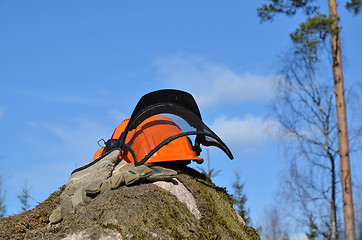 Image showing Helmet and gloves on a rock