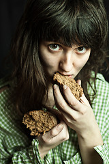 Image showing beggar woman eating bread 