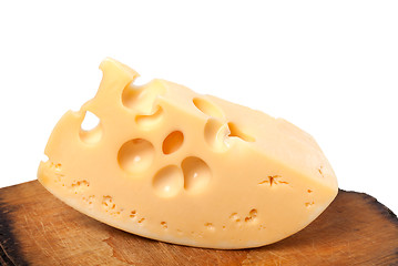 Image showing Piece of cheese on old wooden kitchen table