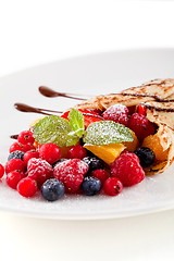 Image showing fresh tasty homemade crepe pancake and fruits