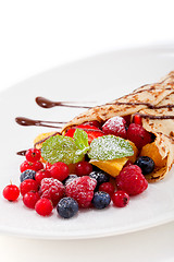Image showing fresh tasty homemade crepe pancake and fruits
