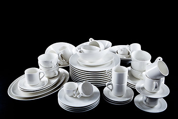 Image showing mixed white dishes cups and plates isolated on black