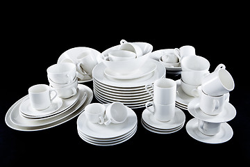 Image showing mixed white dishes cups and plates isolated on black