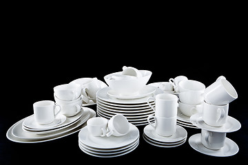 Image showing mixed white dishes cups and plates isolated on black