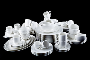 Image showing mixed white dishes cups and plates isolated on black