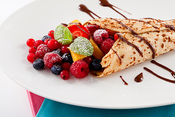 Image showing fresh tasty homemade crepe pancake and fruits