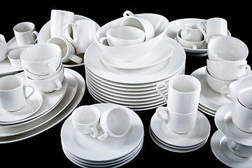 Image showing mixed white dishes cups and plates isolated on black