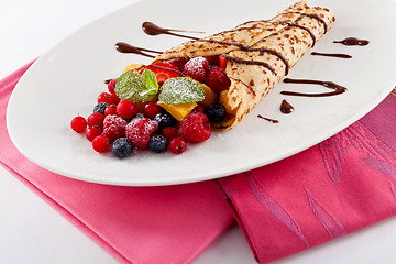 Image showing fresh tasty homemade crepe pancake and fruits