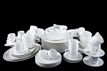 Image showing mixed white dishes cups and plates isolated on black