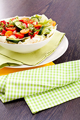 Image showing fresh mixed colorful salad on wooden table 