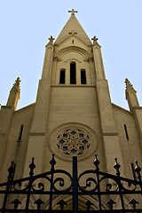 Image showing brick facade rose window and blue sky  