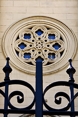 Image showing  colored rose window and a iron grate 