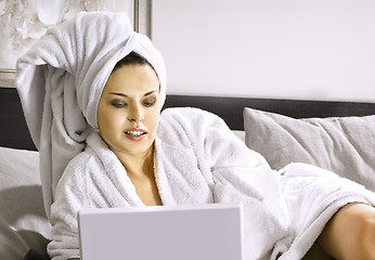 Image showing Lady with laptop on bed