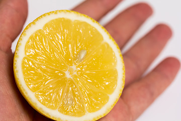 Image showing Half of a lemon in a hand