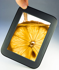 Image showing tablet touch pad computer with lemon
