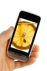 Image showing Mobile phone with lemon splash