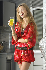 Image showing blonde in modern kitchen with juice