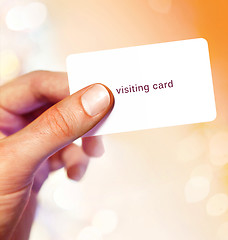 Image showing White visit card in hand